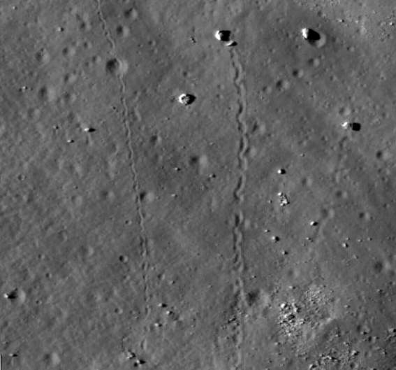 Closeup of LROC image showing boulders that have rolled down the slope of Tsiolkovskiy Crater.  Credit: NASA