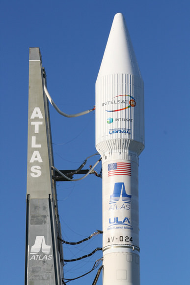 The Atlas 5 will orbit the commercial Intelsat 14 communications satellite.  This photo shows upper portion of rocket and umbilical cord connections leading from mobile launch platform to the decaled 4 meter wide white colored payload fairing and Centaur upper stage.  The flight is designated as tail number AV-024.   Credit: Ken Kremer