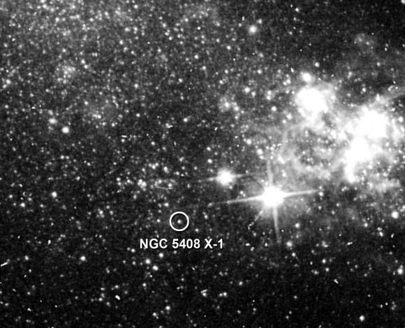 NGC 5408's unusually luminous X-ray source (circled). The irregular-type galaxy lies 15.8 million light-years away in the constellation Centaurus. Credit: NASA/ESA/C. Lang, P. Kaaret, A. Mercer (Univ. of Iowa), and S. Corbel (Univ. of Paris)