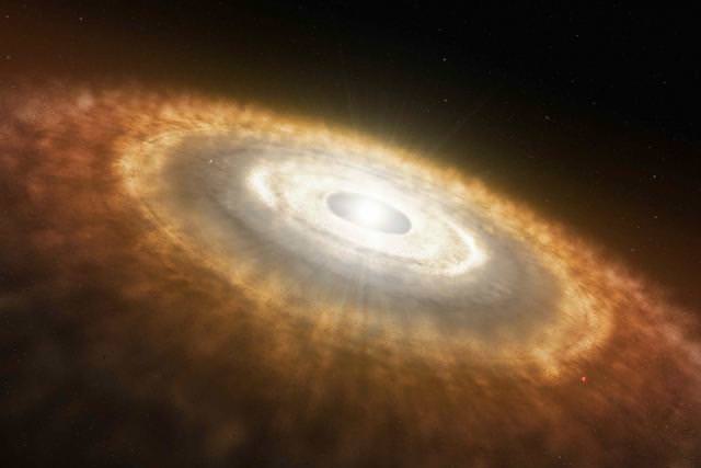 Young stars have a disk of gas and dust around them called a protoplanetary disk. Out of this disk planets are formed, and the presence of water ice in the disc affects where different types of planets form. Credit: NASA/JPL-Caltech