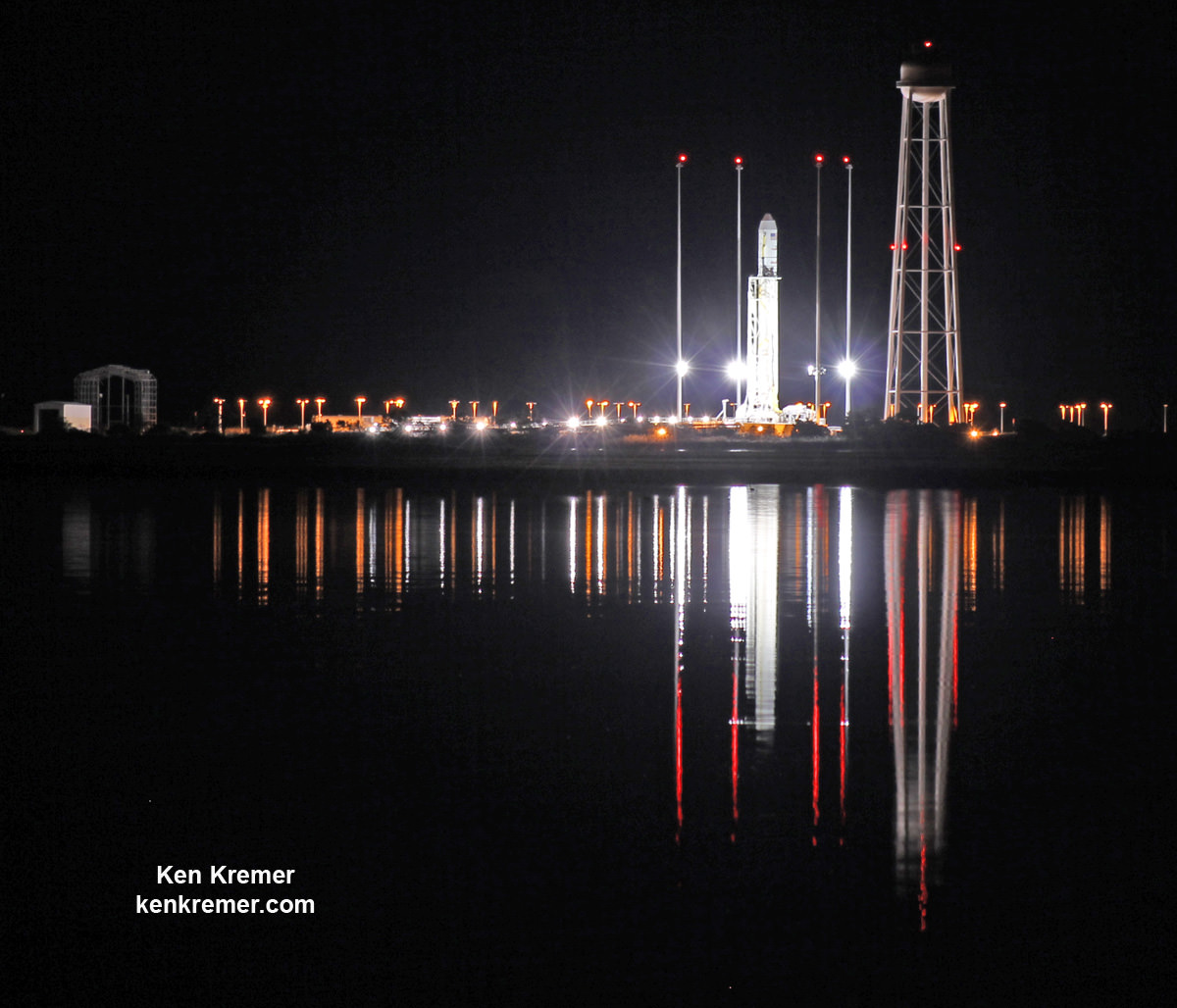 Antares rocket stands erect, reflecting off the calm waters the night before a launch from NASA’s Wallops Flight Facility, VA, on Oct. 28, 2014.    Credit: Ken Kremer/kenkremer.com