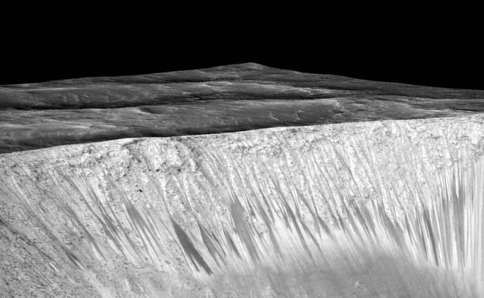 These dark streaks, called recurring slope lineae, are on a sloped wall on a crater on Mars. A new study says they may have been formed by boiling water. Image: NASA/JPL-Caltech/Univ. of Arizona