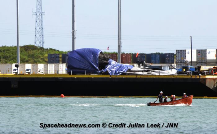 Flattened SpaceX Falcon 9 first stage arrived into Port Canaveral, FL atop a droneship late Saturday, June 18 after hard landing and tipping over following successful June 15, 2016  commercial payload launch.  Credit: Julian Leek