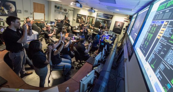 New Horizons flight controllers celebrate after they received confirmation of the spacecraft's successful flyby of Pluto on July 14, 2015. Credit: NASA/Bill Ingalls. 