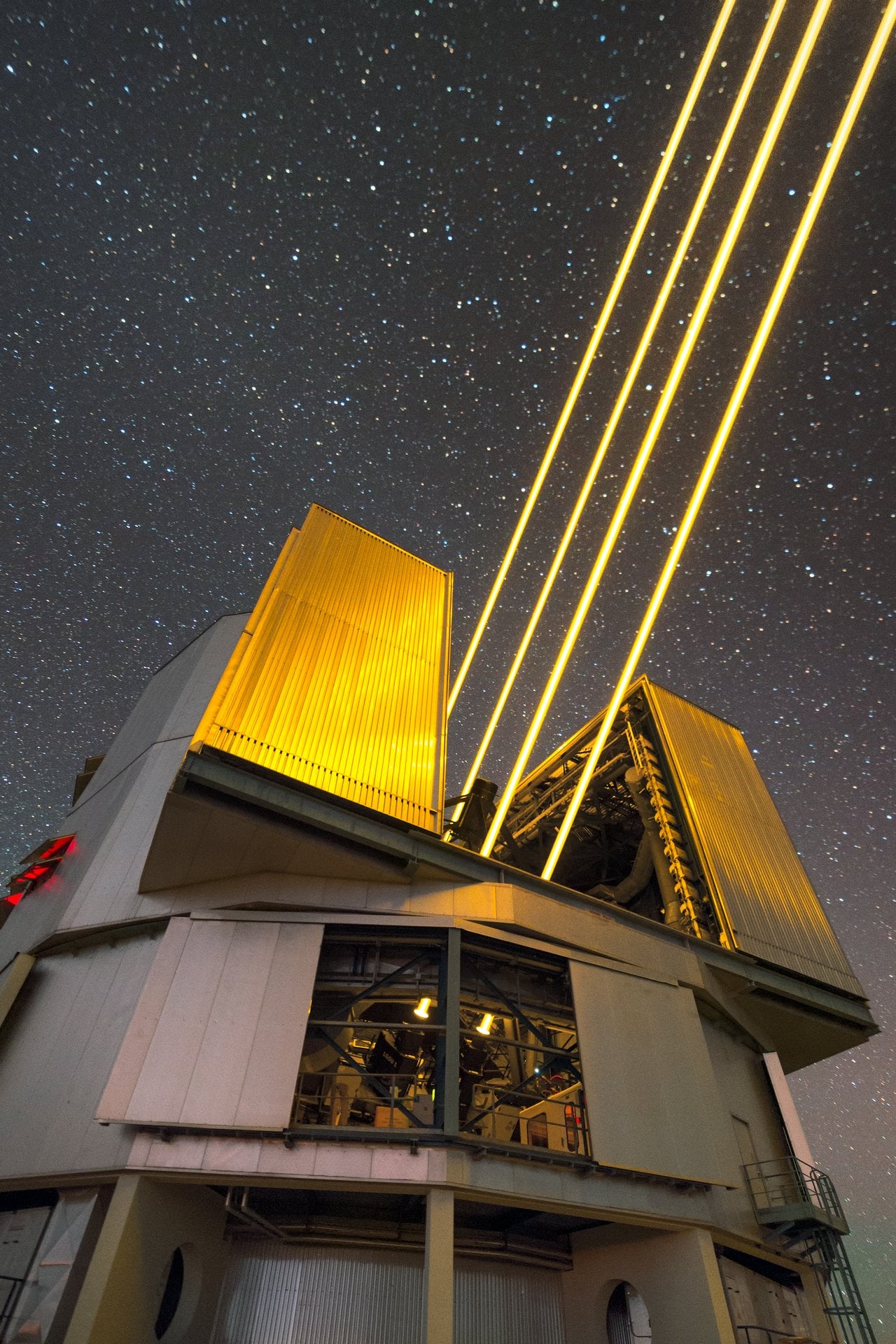 Glowing beams from the 4 Laser Guide Star Facility. Credit - ESO/P. Horálek