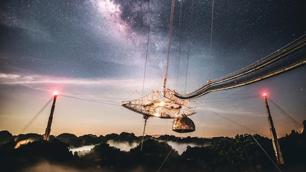 The legacy of Arecibo's nearly 60 years of radio astronomy is strong even after its loss in a tragic 2020 collapse. Among its major accomplishments was hosting the first attempt at Messaging Extraterrestrial Intelligence (METI). Credit: University of Central Florida