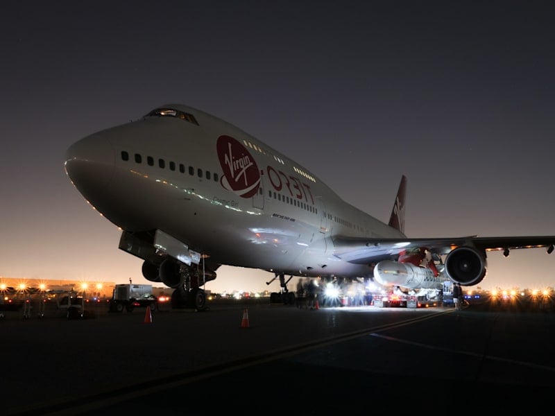 Launcher One attached to Cosmic Girl. The rocket attaches to a custom launch pylon underneat the portside wing. Image: Virgin Orbit.