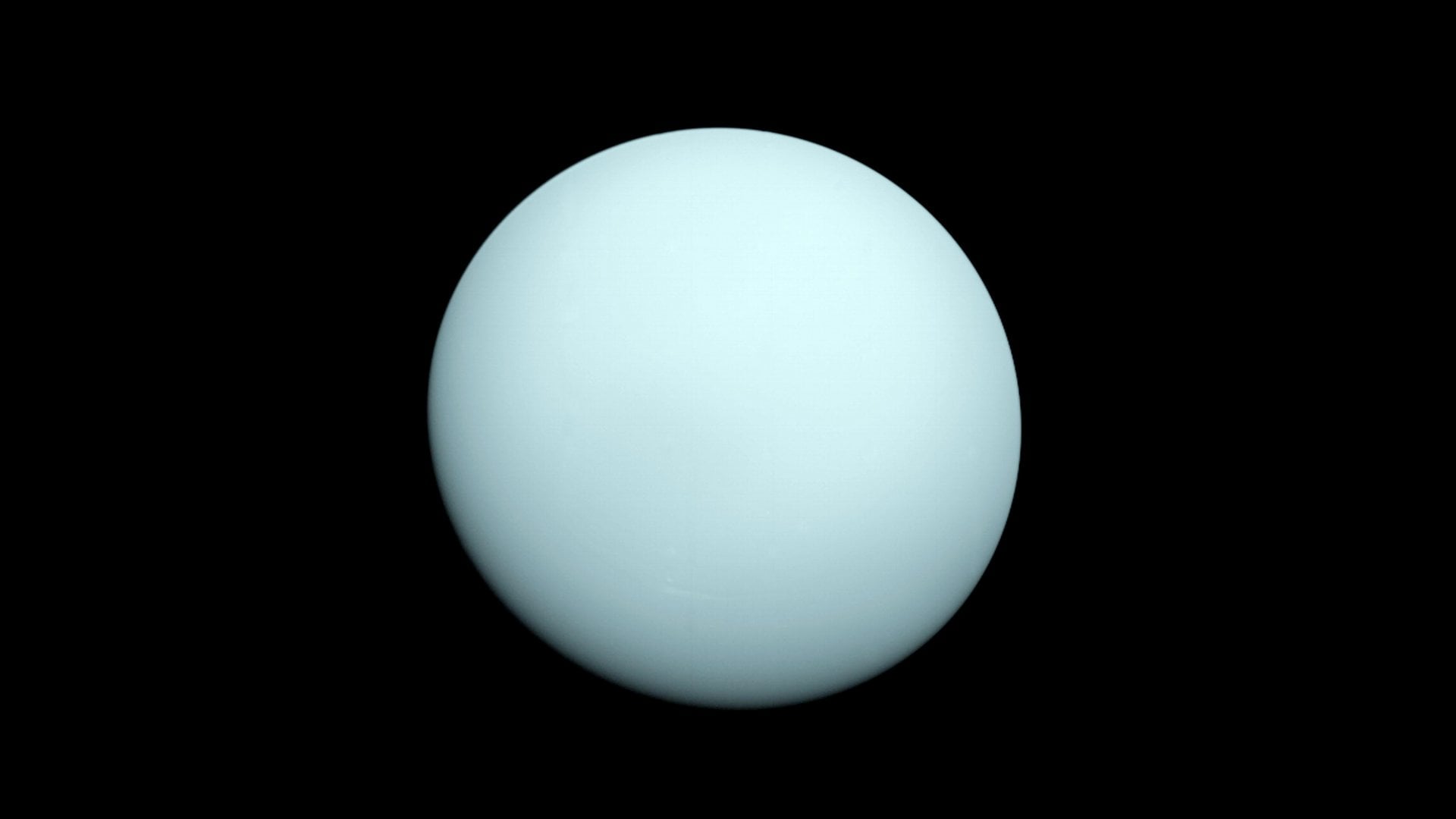 Voyager 2 saw Uranus as a near-featureless grey-green orb when it flew past the planet in 1986. Credit: NASA/JPL-Caltech