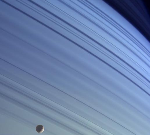 Saturns rings with Saturns moon Mimas in the foreground (credit: NASA)
