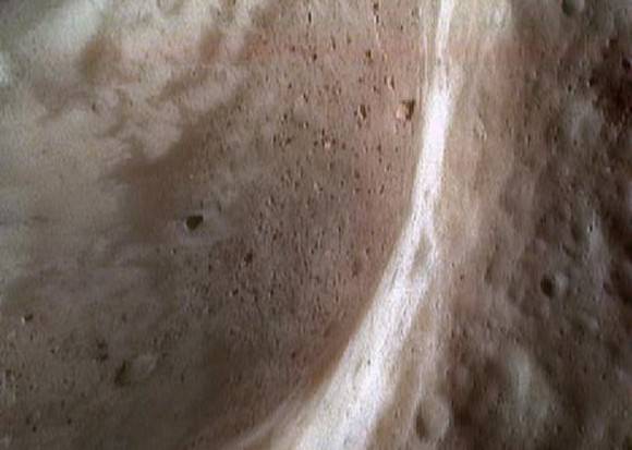 False color picture of Eros' 5.3-kilometer (3.3-mile) surface crater, showing regolith inside. Credit: NASA/JPL/JHUAPL 