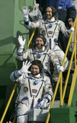 The cosmonaut, astronaut and space tourist wave to onlookers before boarding Soyuz (AP Photo)