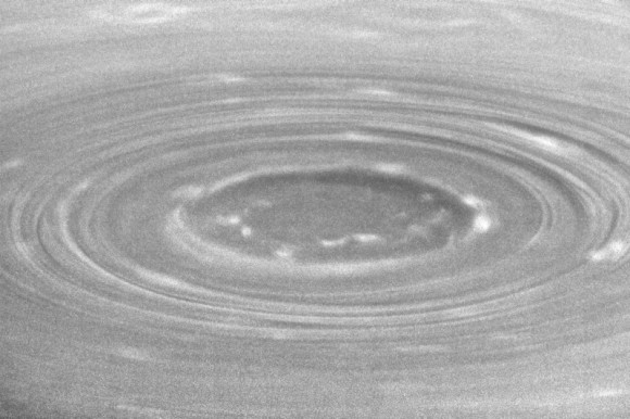 Oblique view of Saturn's south polar vortex. The Sun is located above the top-right-hand corner, showing the shadows of clouds towering above the vortex (NASA)