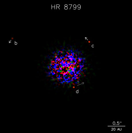 Three exoplanets orbiting a young star 140 light years away are captured using Keck Observatory near-infrared adaptive optics. The planets are labeled and the two outer ones have arrows showing the size of their motion over a 4 year period.  