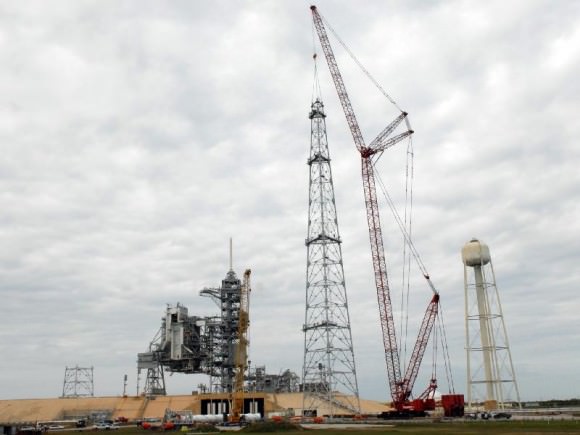 On Launch Pad 39B at NASA's Kennedy Space Center, a crane completes construction of one of the towers in the new lightning protection system for the Constellation Program. Credit: NASA