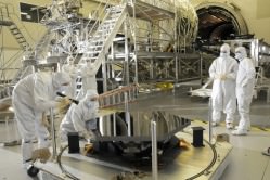 Engineers from Ball Aerospace inspect the first James Webb Space Telescope mirror segment upon its arrival at Marshall Space Flight Center, Huntsville, Al. for cryogenic testing. Credit: NASA