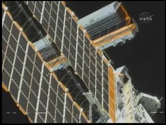 The S6 blanket box before deploy (behind the arrays unfurled during a previous mission). Credit: NASA TV