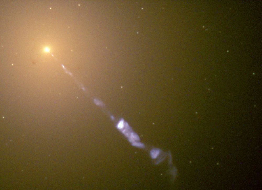 A Hubble Space Telescope view of M87's core and its jet. it points nearly directly at us and is also known as a blazar. Astronomers are studying other blazars that have meandering jets and think that binary black holes may be hidden inside some of them. Courtesy STScI.