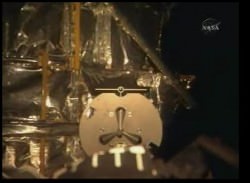 The view from the shuttle's RMS camera of the grapple fixture on Hubble. NASA TV.