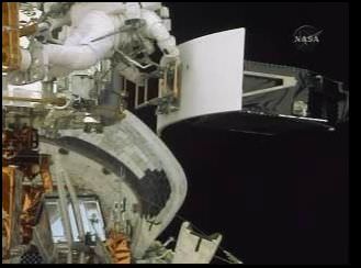 Feustel carrying the old WFPC2 down to the shuttle's payload bay. Credit: NASA TV