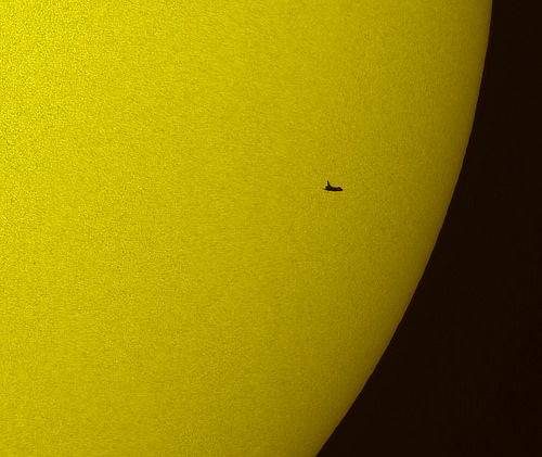 In this tightly cropped image, the NASA space shuttle Atlantis is seen in silhouette during solar transit, Tuesday, May 12, 2009, from Florida. This image was made before Atlantis and the crew of STS-125 had grappled the Hubble Space Telescope. Photo Credit: (NASA/Thierry Legault) 