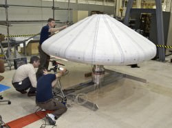 NASA engineers check out the Inflatable Re-entry Vehicle Experiment (IRVE) in the lab. Credit: NASA/Sean Smith