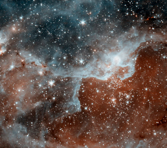 Spitzer's infrared eyes can both see dust and see through dust. The blue areas are dusty clouds, and the orange is mainly hot gas.
