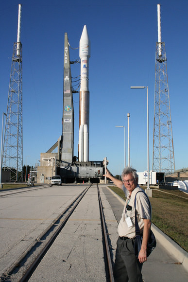 Ken Kremer with the Atlas launch vehicle at Pad 41 which will fly in the 431 configuration with 3 solid rocket boosters attached to the first stage and a single engine white colored Centaur upper stage. The Atlas 5 was rolled out to launch pad on Nov 12. Note tracks at center. The Intelsat satellite is encapsulated in a 4 meter wide extra extended payload fairing.  A similar Centaur stage impacted the moon as part of the LCROSS mission.