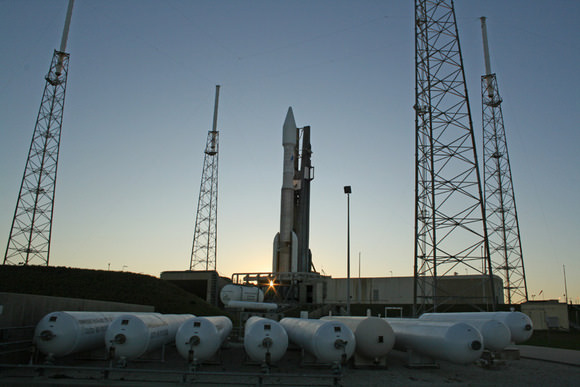 Atlas 5 rocket at sunset surrounded by 4 lightening masts at pad 41. Multiple tanks of compressed gaseous nitrogen at 4800 psi in foreground.   A technical glitch with the ORCA electronics unit critical for flight control forced a scrub for what would have been the 19th flight of an Atlas 5.  Credit: Ken Kremer
