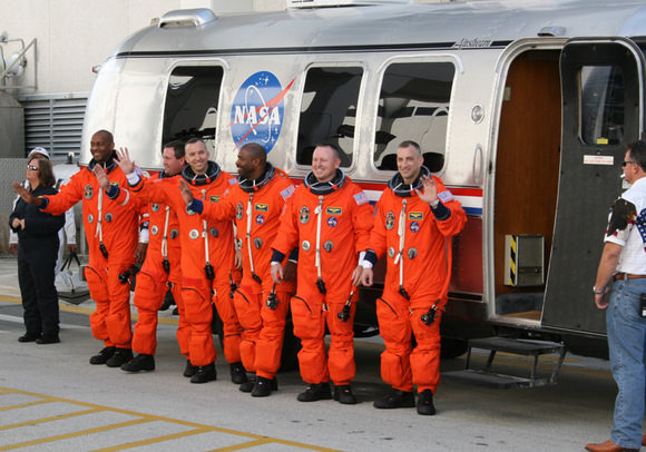 The six person crew of Space Shuttle Atlantis walk out from crew quarters at 10:38 AM to greet the cheering crowd of media and NASA officials and then head out to pad 39 A to strap in for space launch with hours.  Credit: Ken Kremer    