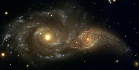 A Grazing Encounter Between Two Spiral Galaxies (NGC 2207 and IC2163).  Credit: HubbleSite