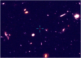 A portion of the Hubble Ultra Deep Field showing the location of a potentially very distant galaxy (marked by crosshairs).   Credit: Oxford University