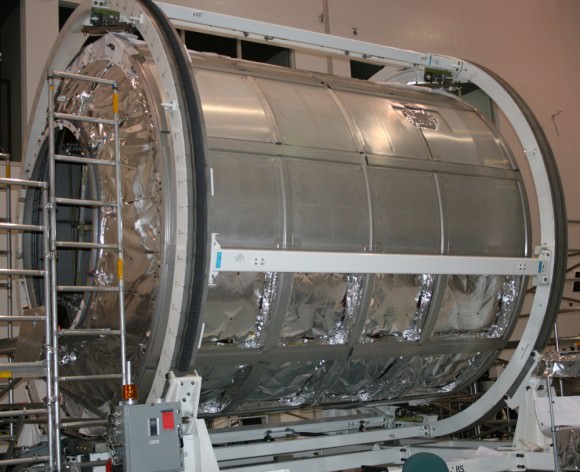 ‘Donatello’ MPLM module inside the Space Station Processing Facility at KSC.  This module is being utilized for spare parts. Outer shielding is being removed.   Credit: Ken Kremer