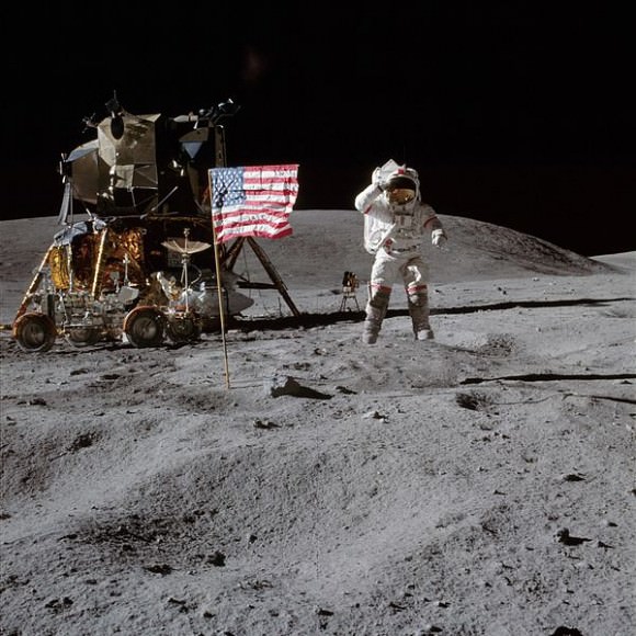 John Young - caught mid-leap - salutes the American flag on the lunar surface. Credit: NASA.