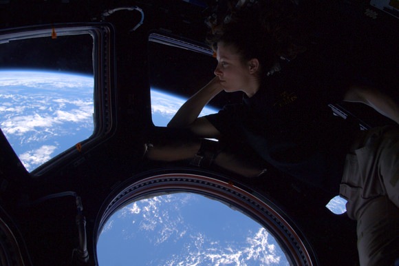 Astronaut Tracy Caldwell Dyson reflects on the view from the ISS's Cupola. Credit: Doug Wheelock/NASA