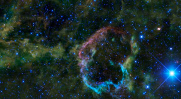 This oddly colorful nebula is the supernova remnant IC 443 as seen by WISE. Image credit: NASA/JPL-Caltech/UCLA