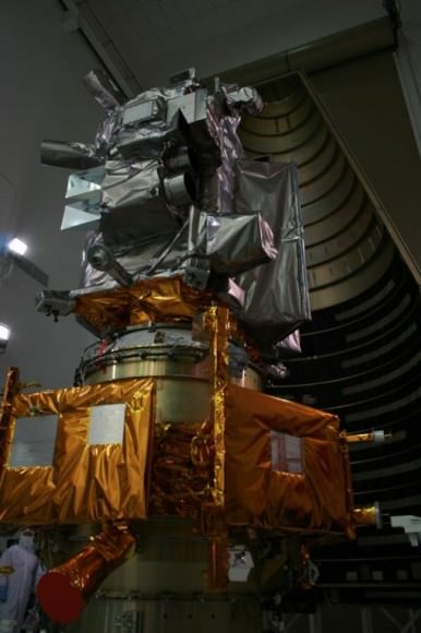 LRO spacecraft (top) protected by gray colored blankets is equipped with 7 science instruments located at upper right side of spacecraft. LRO cameras are pointing to right. LRO is piggybacked atop NASA’s LCROSS spacecraft.  Payload fairing in background protects the spacecraft during launch and ascent. Credit: Ken Kremer 