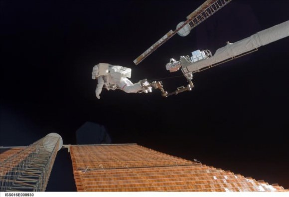 November 3, 2007 – Canadarm2 played a big role in helping astronauts fix a torn solar array.  The arm’s reach was extended by the Orbiter Boom Sensor System, and here, allowing astronaut Scott Parazynski analyses the solar panel while anchored to the boom. Credit: NASA