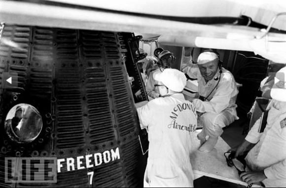 John Glenn crouches near Shepard's capsule, Freedom 7, along with technicians prior to launch. Credit: Ralph Morse/TIME & LIFE Pictures. Used by permission.