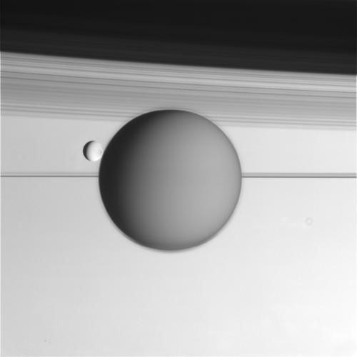 Raw Cassini image of Titan and Enceladus backdropped by Saturn's rings. Image Credit: NASA/JPL/Space Science Institute