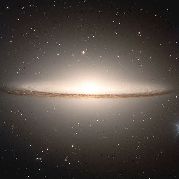The Milky Way is like NGC 4594 (pictured), a disc shaped spiral galaxy with around 200 billion stars. The three main features are the central bulge, the disk, and the halo. Credit: ESO
