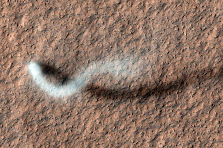 A towering dust devil, casts a serpentine shadow over the Martian surface in this image acquired by the High Resolution Imaging Science Experiment (HiRISE) camera on NASA's Mars Reconnaissance Orbiter. Image credit: NASA/JPL-Caltech/Univ. of Arizona