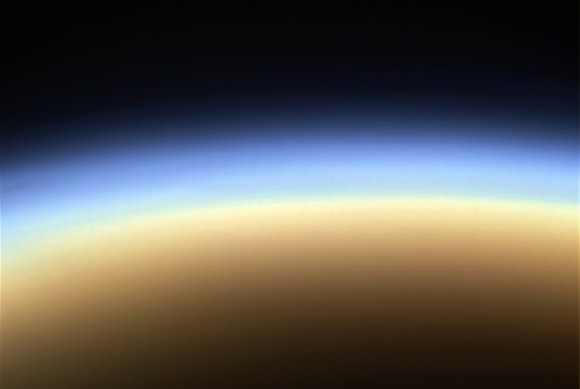 What other surprises may be found beneath Titan's thick haze and clouds? (NASA/JPL/SSI/J. Major)