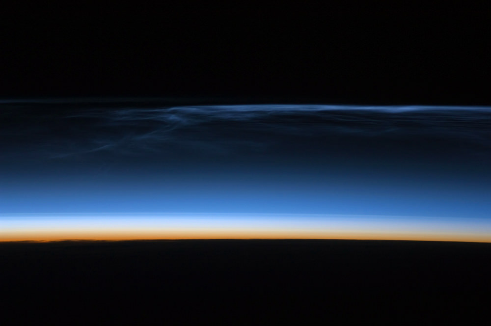 Noctilucent clouds taken from the ISS Image Credit: NASA