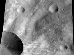 This image from NASA’s Dawn spacecraft shows a close up of part of the rim around the crater Canuleia on the giant asteroid Vesta. Canuleia, about 6 miles (10 kilometers) in diameter, is the large crater at the bottom-left of this image. Image credit: NASA/JPL-Caltech/UCLA/MPS/DLR/PSI/Brown