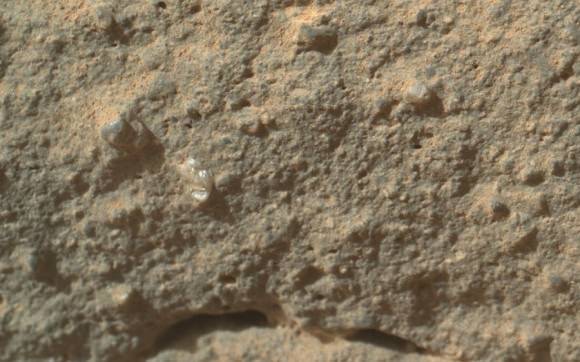 A bright and interestingly shaped tiny pebble shows up among the soil on a rock, called "Gillespie Lake," which was imaged by Curiosity's Mars Hand Lens Imager on Dec. 19, 2012, the 132nd sol, or Martian day of Curiosity's mission on Mars. Credit: NASA / JPL-Caltech / MSSS.