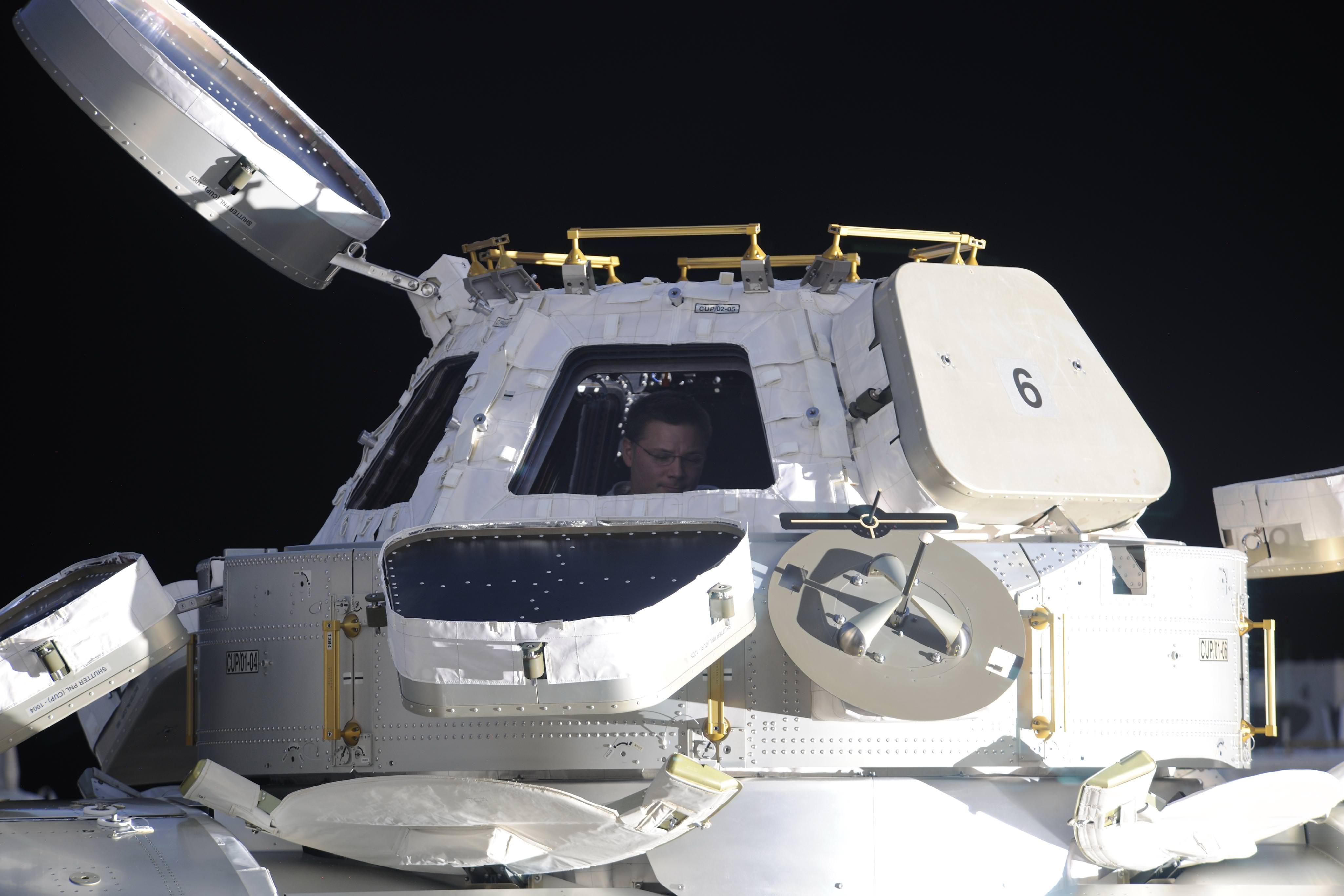 From the outside, the cupola looks like an extraterrestrial spacecraft. That's Douglas Wheelock (Expedition 25) inside the window. Credit: NASA