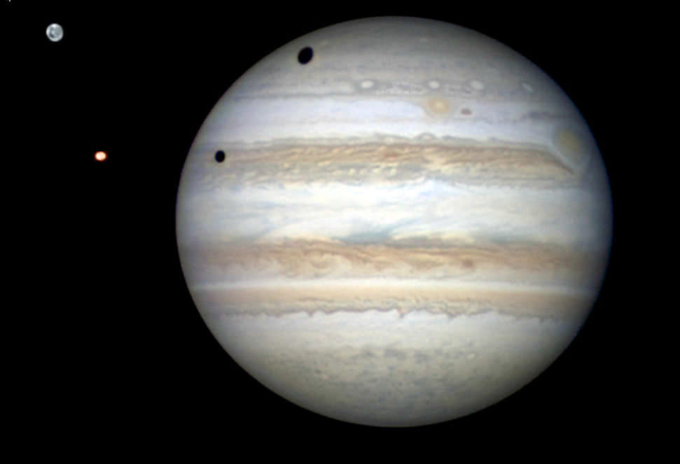 A rare double transit of Jupiter's moon Ganymede (top) and Io on Jan. 3, 2013. Here, the sun is shining from the left causing shadows cast by the moons to fall onto the planet's cloud tops. Credit: Damian Peach