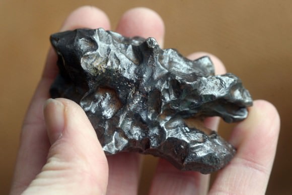 A fragment of the Sikhote-Alin iron meteorite that fell over eastern Russia (then the Soviet Union) on Feb. 12, 1947. Some of the dimpling are pockets on the meteorite's surface called regmeglypts. Credit: Bob King