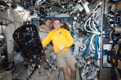NASA astronauts Kevin Ford (foreground) and Tom Marshburn working with the Combustion Integrated Rack (CIR) Multi-user Droplet Combustion Apparatus (MDCA) in the ISS' Destiny laboratory on Jan. 9 (NASA)