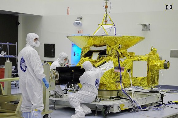 New Horizons in the Payload Hazardous Servicing Facility at the Kennedy Space Center. Note the RTG (black) protruding from the spacecraft. (Credit: NASA/Uwe W.)